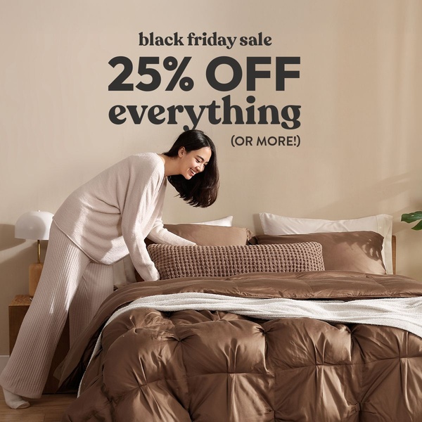 A minimalist promotional ad featuring a woman arranging bedding, highlighting a significant Black Friday discount.