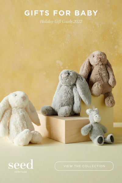 A clean, warm-toned studio shot featuring soft plush rabbits as seasonal gift items. The image uses a minimalist composition to highlight product variety and texture.