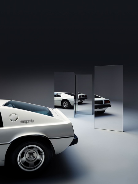A high-end studio shot of a white sports car positioned next to reflective panels, creating a clean, futuristic, and premium automotive look.