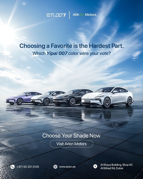 A high-quality lifestyle shot featuring multiple color variations of an electric sedan on a wet, reflective surface under a bright sun.