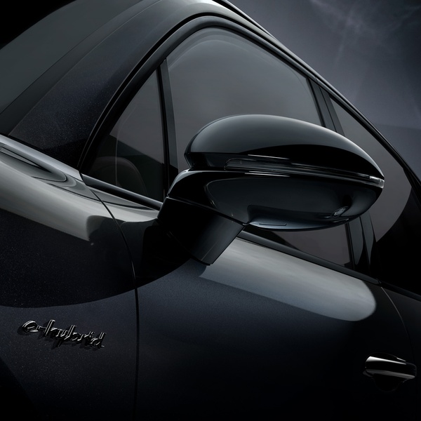 A high-contrast, moody close-up photograph focusing on the side mirror and e-hybrid badge of a luxury vehicle to evoke status and engineering precision.
