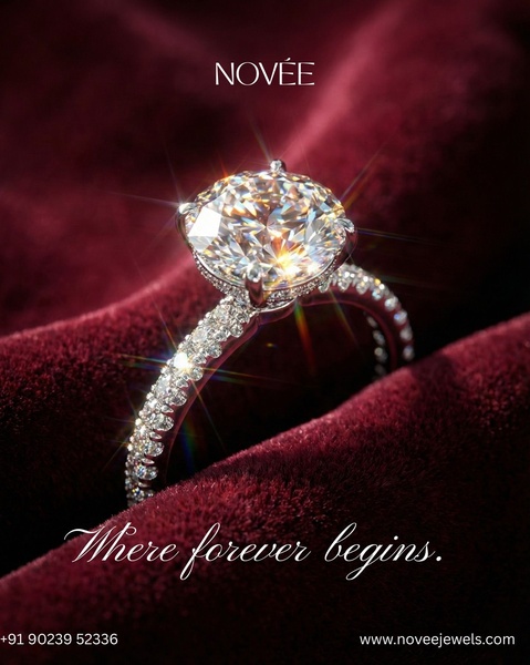 A close-up shot of a brilliant-cut diamond engagement ring resting on rich, dark red velvet with soft, dramatic lighting.