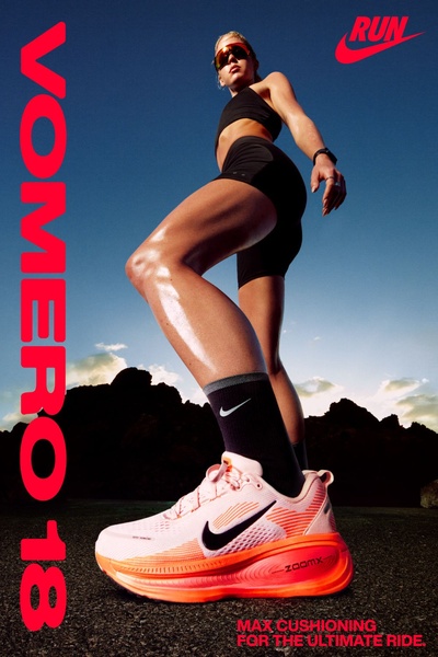 A high-contrast advertisement for a running shoe featuring a low-angle shot of an athlete in motion against a clear blue sky, emphasizing product cushioning.