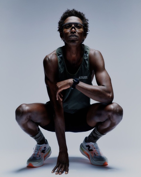 A low-angle studio shot featuring a runner in a crouched, ready-to-sprint pose, highlighting high-end running shoe design.