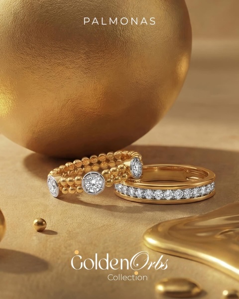 A close-up, high-end product hero shot featuring two diamond-encrusted gold rings displayed against a warm, metallic background.