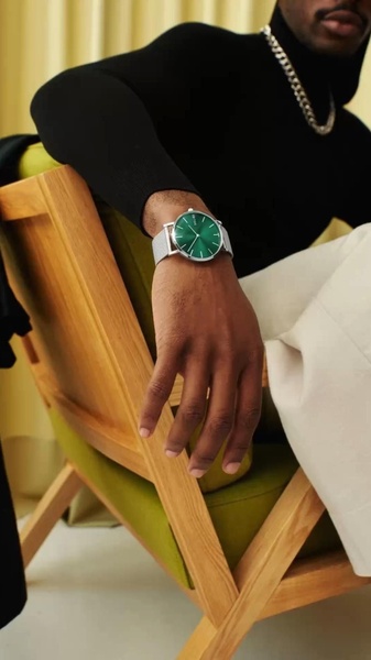 wrist watch, analog watch, mesh strap watch, minimalist watch, green face watch, brand awareness, lifestyle, editorial, calm, luxurious, green, neutral