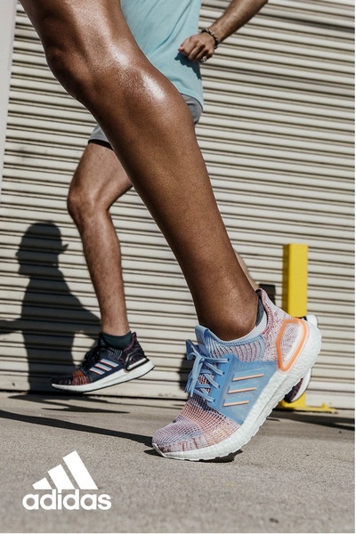 A close-up, low-angle action shot of a person running, specifically highlighting the design and comfort of the featured running shoe.