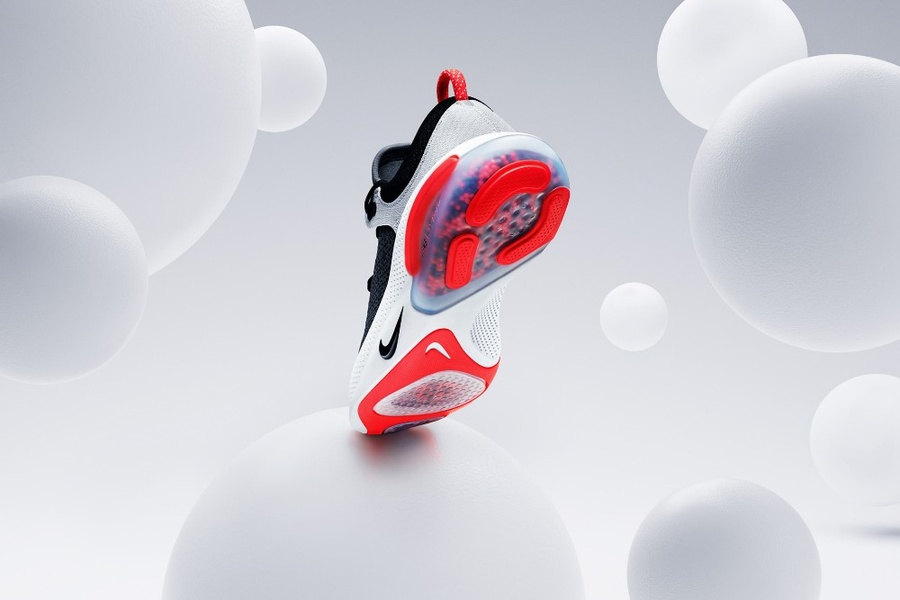 A high-end product hero shot featuring a running shoe suspended among white spheres to highlight design details in a clean, professional studio environment.