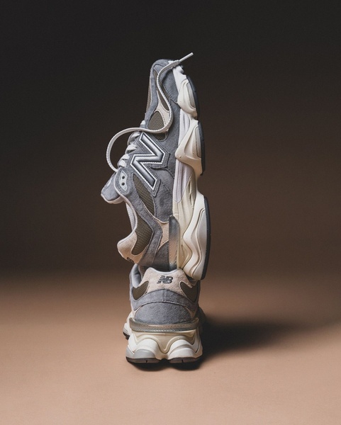 A vertical stack of two running shoes against a muted, professional backdrop that creates a sense of high-end quality.