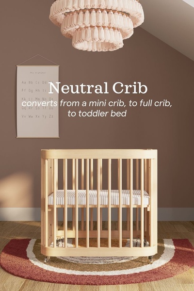 A clean, studio-lit image of a convertible crib highlighting its transformation from mini to full-size and toddler bed.