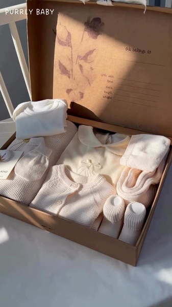 baby gift set, newborn clothing kit, baby shower gift, newborn outfit set, baby layette set, gift guide, minimalist, flat lay, calm, warm, neutral