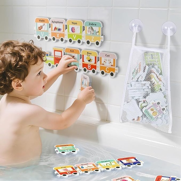 A high-contrast, brightly colored product shot showing a toddler interacting with educational alphabet train toys on a tiled bathroom wall.
