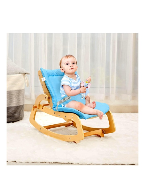 A high-quality lifestyle shot featuring a baby sitting comfortably in a wood-frame rocking chair with blue cushions.