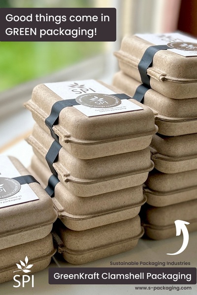 A vertical image showcasing stacked, eco-friendly food clamshells branded with minimalist labels against a bright, natural backdrop.