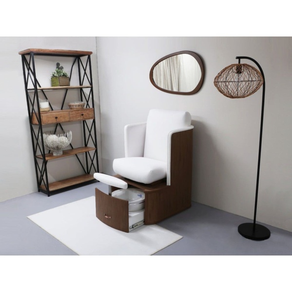 A high-end, studio-lit photograph of a modern pedicure chair in a minimalist room, emphasizing a clean and premium brand identity.