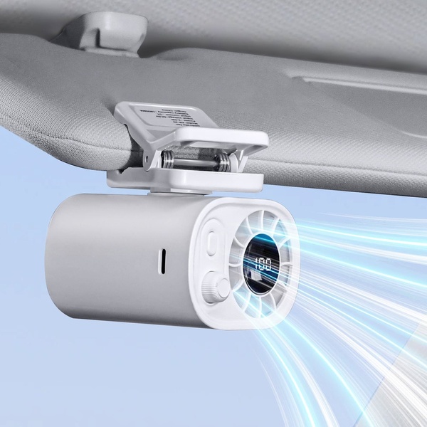 A close-up shot of a white car clip fan attached to a sun visor, using digital graphic overlays to show powerful, directed airflow cooling.