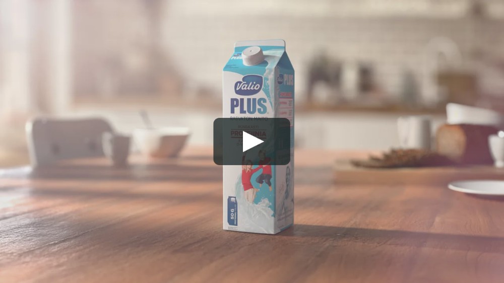 A high-quality product shot of a Valio Plus milk carton sitting on a kitchen table, using natural lighting to emphasize freshness and product purity.