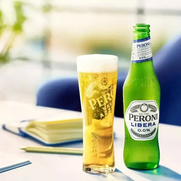 A high-clarity, professional studio shot of a glass and bottle of alcohol-free beer, designed to emphasize refreshment and premium quality.