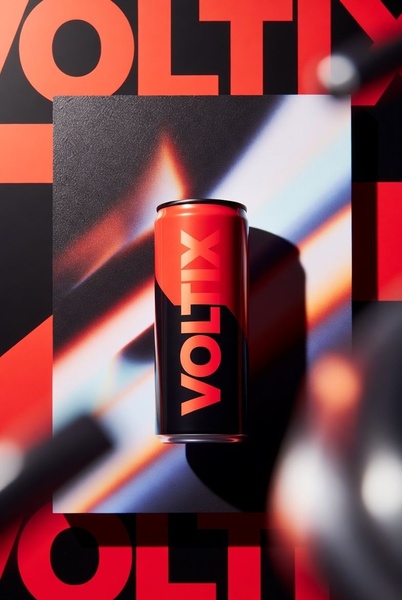 A sharp, high-contrast product shot of an energy drink can set against a modern, red and black geometric background with light flares.