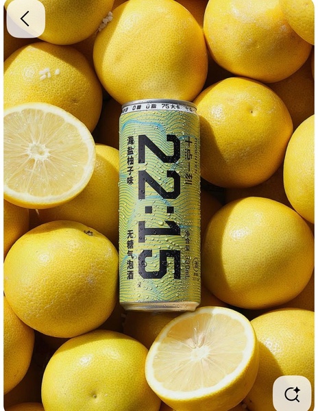 A high-contrast, professional product hero shot of a 22:15 brand canned drink surrounded by fresh, halved grapefruits.