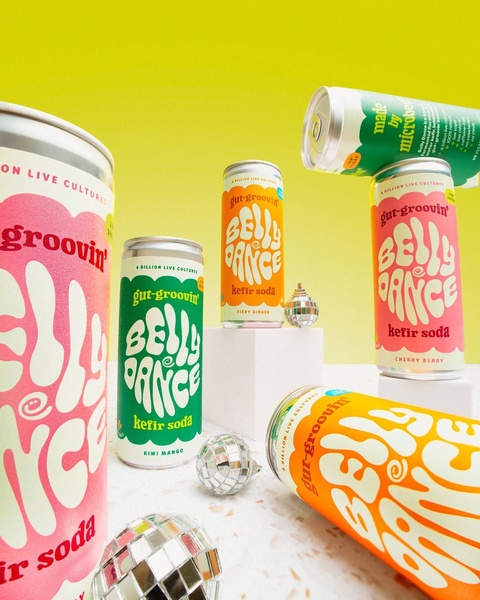 A vibrant, 4:5 aspect ratio creative featuring multiple cans of kefir soda arranged around disco balls against a bright yellow background.