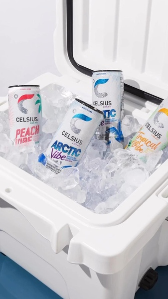This creative showcases multiple flavored energy drinks arranged in a white cooler packed with crushed ice, emphasizing a cool and refreshing product appeal.
