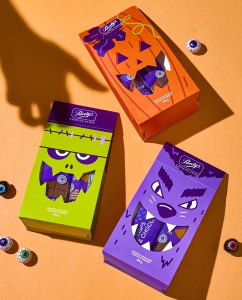 boxed chocolate, milk chocolate, assorted chocolate, halloween candy, chocolate gift, new arrival, flat lay, playful, orange, green, purple, halloween