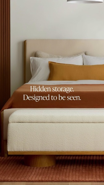 A high-end, minimalist photograph of a boucle fabric storage bench at the foot of a bed, emphasizing a 'hidden storage' value proposition.