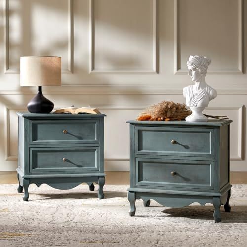 A high-quality, 1:1 ratio studio shot of a blue wooden nightstand, styled with a desk lamp and a decorative bust in a clean, minimalist interior.