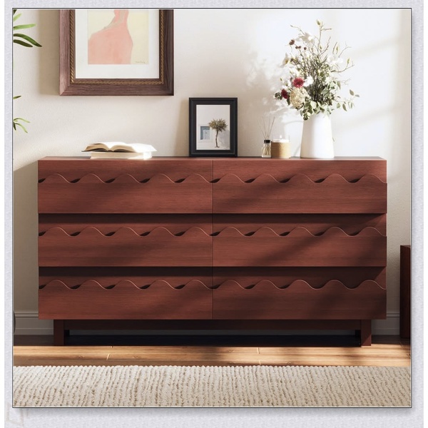 A high-quality lifestyle shot of a wooden Wavefront Dresser centered in a bright, modern room, emphasizing its unique design and materiality.