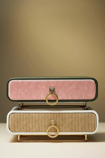 A high-end, clean product photography shot of two stacked, ribbed jewelry boxes against a warm, neutral background.