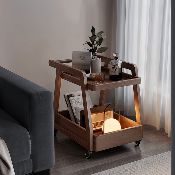 A high-end, lifestyle-focused shot of a wooden bar cart featuring curated decor, books, and ambient lighting in a warm interior.