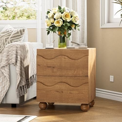 A high-quality lifestyle shot of a modern wooden nightstand featuring a wavy drawer design, styled with a floral bouquet in a bright, airy bedroom setting.