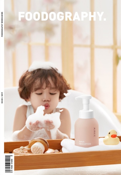 A soft, lifestyle-focused ad showing a child playing with shampoo bubbles next to the product bottle.