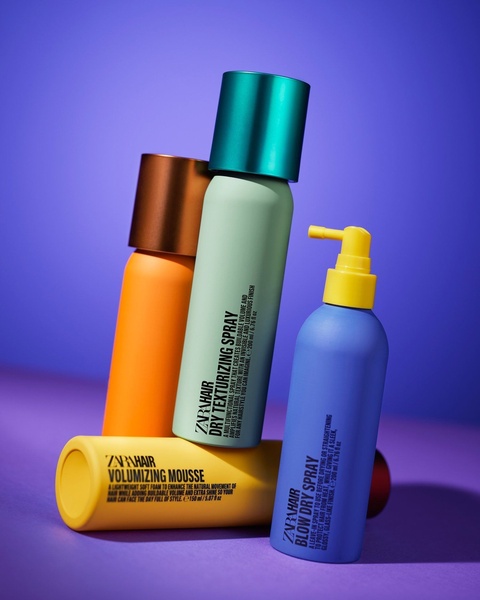 This creative showcases four distinct hair care products arranged in a clean, studio-lit composition against a high-contrast purple backdrop.