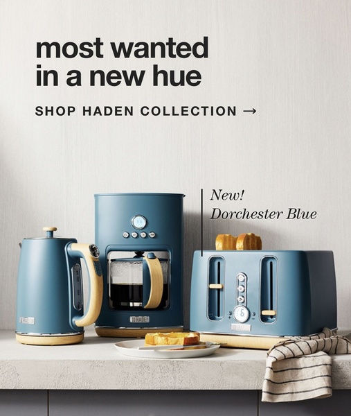 A high-end product hero shot featuring a kettle, coffee maker, and toaster in a signature Dorchester Blue finish set against a clean, neutral background.