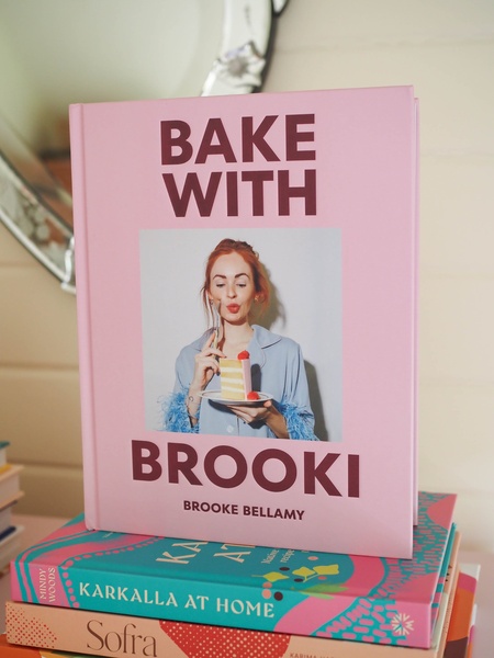 A high-quality product photography shot featuring a cookbook cover centered against a minimalist background, focusing on brand clarity and aesthetic appeal.