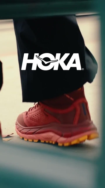 A close-up, low-angle shot of a running shoe in motion, highlighting the tread design and color palette through rhythmic movement.