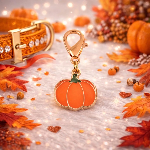 A close-up, high-quality product shot of a pumpkin-shaped pet tag resting on a white fuzzy surface, surrounded by autumn leaves and soft bokeh lights.
