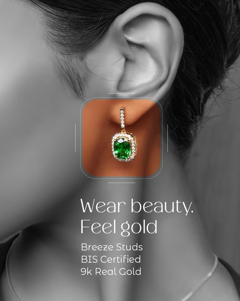 A close-up aesthetic shot featuring gold and green earrings against a model profile, highlighting luxury and detail.