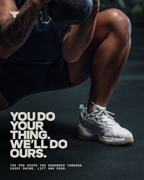 A close-up, low-angle shot of a training shoe in use during a weighted workout, highlighting the product as an essential part of the athlete's routine.