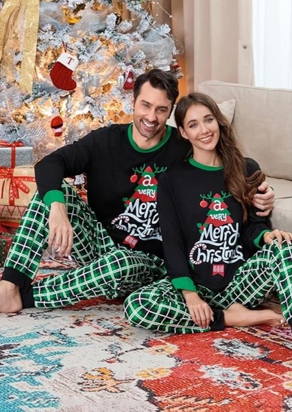 A festive lifestyle shot featuring a smiling couple in matching plaid Christmas pajamas in front of a decorated tree.