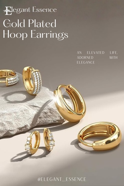 A high-end, minimalist product hero shot featuring a selection of gold-plated hoop earrings arranged on a textured stone surface.