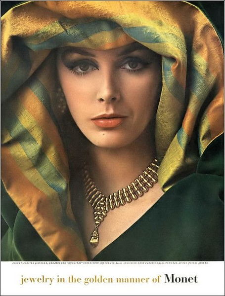 This ad features a high-fashion, editorial-style close-up of a model wearing a gold necklace, utilizing soft, rich lighting to emphasize elegance.