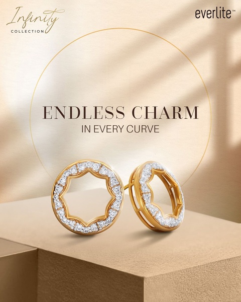 A high-end, minimalist product shot of gold earrings featuring a circular, geometric design set against a warm, soft-focus gradient background.