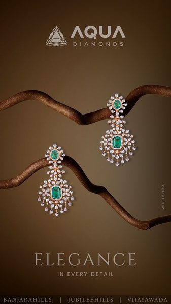 A high-end studio shot of emerald and diamond earrings displayed on a natural branch, emphasizing detail and elegance.