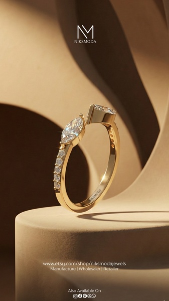 This creative showcases a gold marquise-cut diamond ring floating against a neutral, sculpted architectural background.