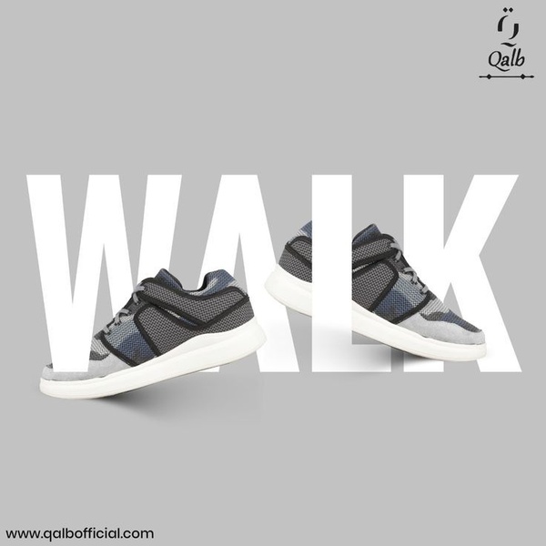A clean, high-contrast ad featuring a pair of running shoes integrated with oversized white typography on a neutral grey background.
