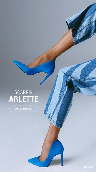A high-contrast vertical shot featuring a model showcasing vibrant blue heels with matching denim, focusing entirely on product placement.