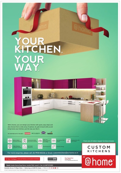 A clean, studio-lit ad showing a full custom kitchen set being lifted out of a gift box, symbolizing the ease and tailored nature of the service.